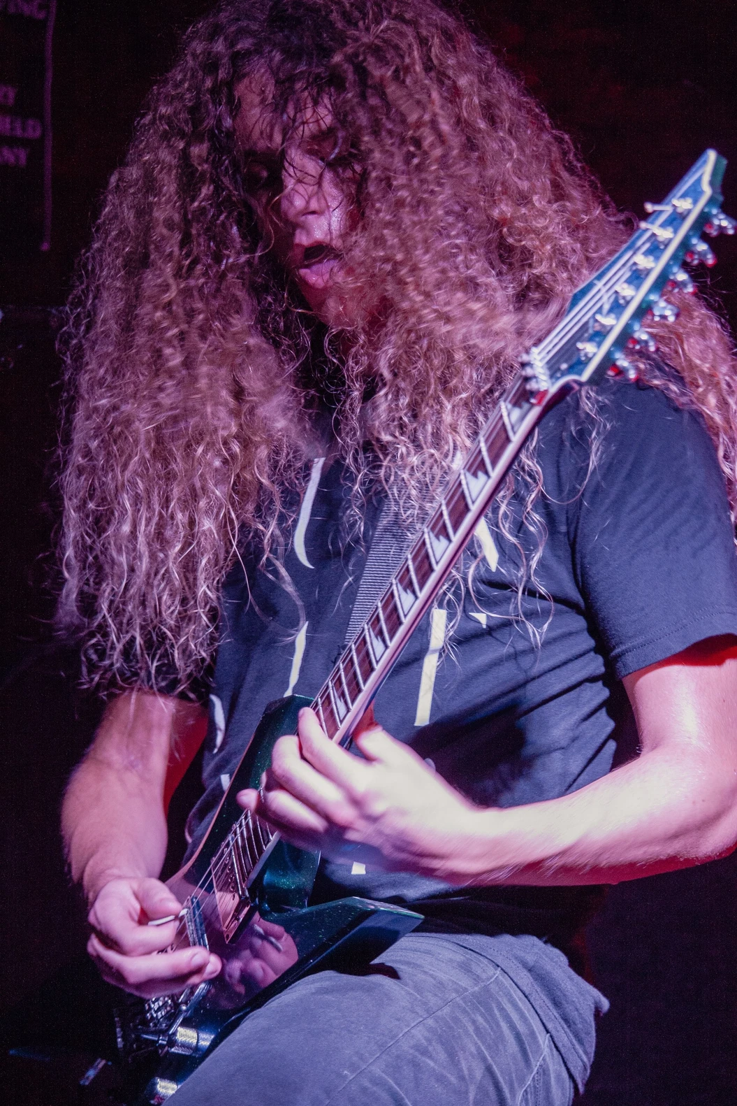 An illustrated character with blue hair is submerged underwater, reaching upward with one hand. Bubbles and small planets are visible around them, creating an ethereal and dreamy atmosphere.