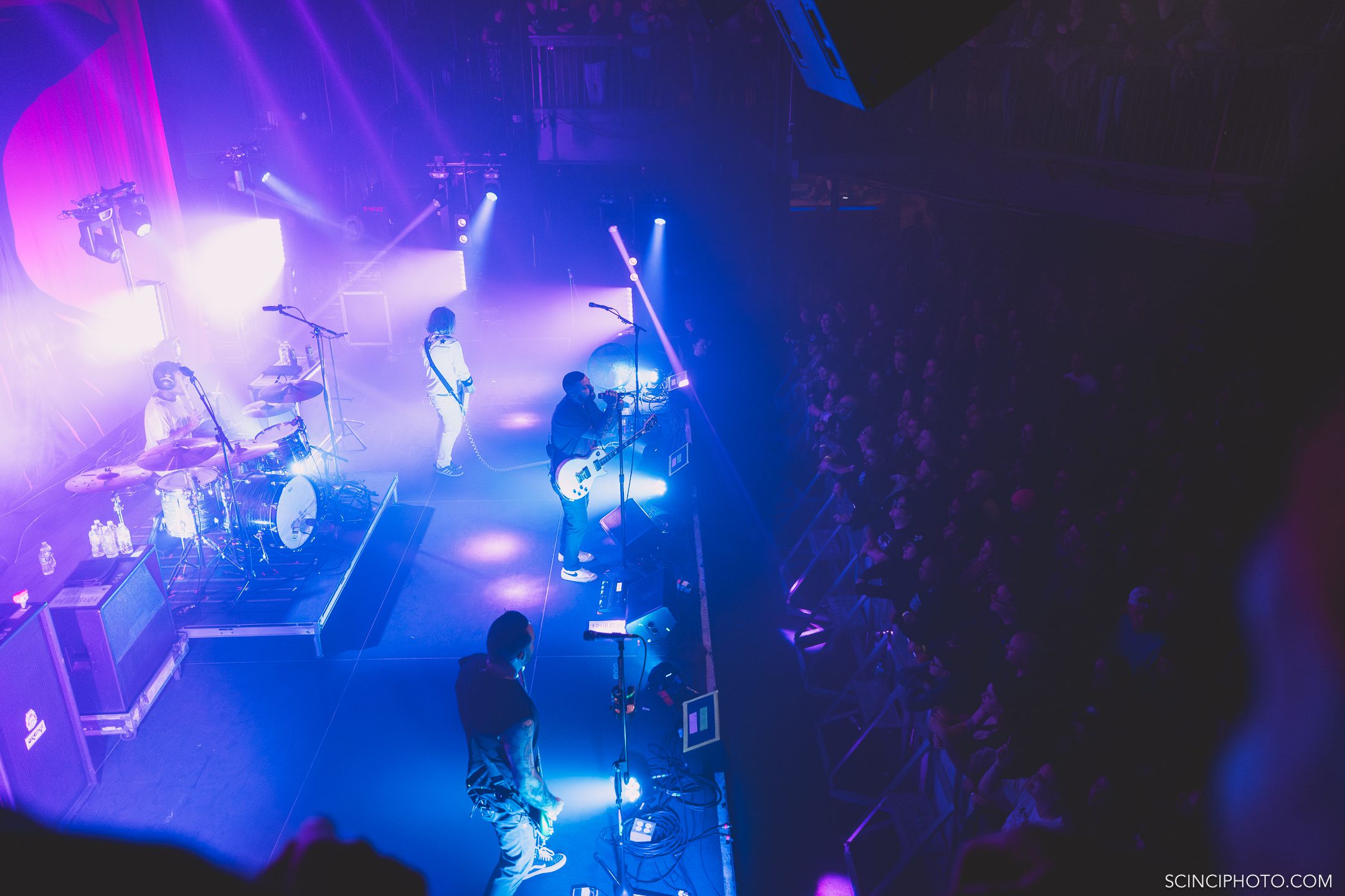 A photo of the band 'A Tragedy At Hand' posing against a dark background, featuring four male members with varying hairstyles and tattoos.