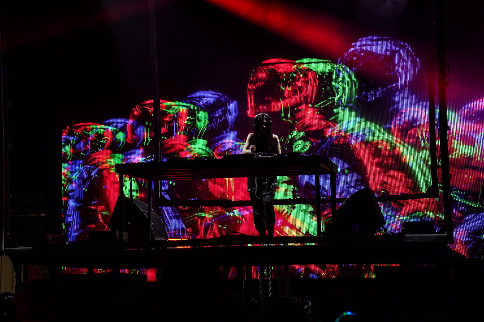 Musicians performing on stage with a backdrop displaying the band's name 'MICROWAVE' during a live concert.