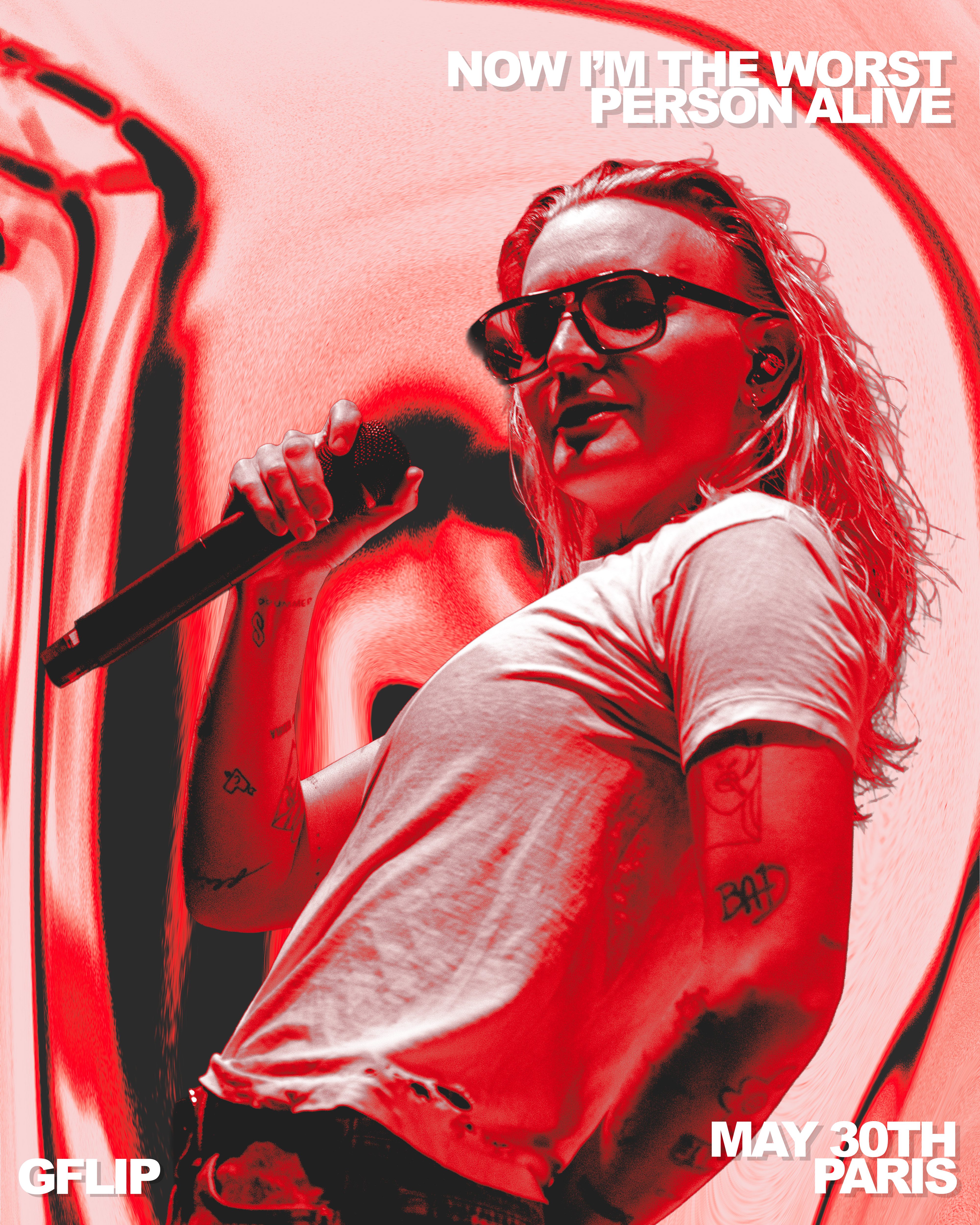 A performer on stage holding a microphone, wearing sunglasses and a white shirt, with vibrant red and abstract background effects. Text overlay reads: 'NOW I'M THE WORST PERSON ALIVE' and 'MAY 30TH PARIS'.