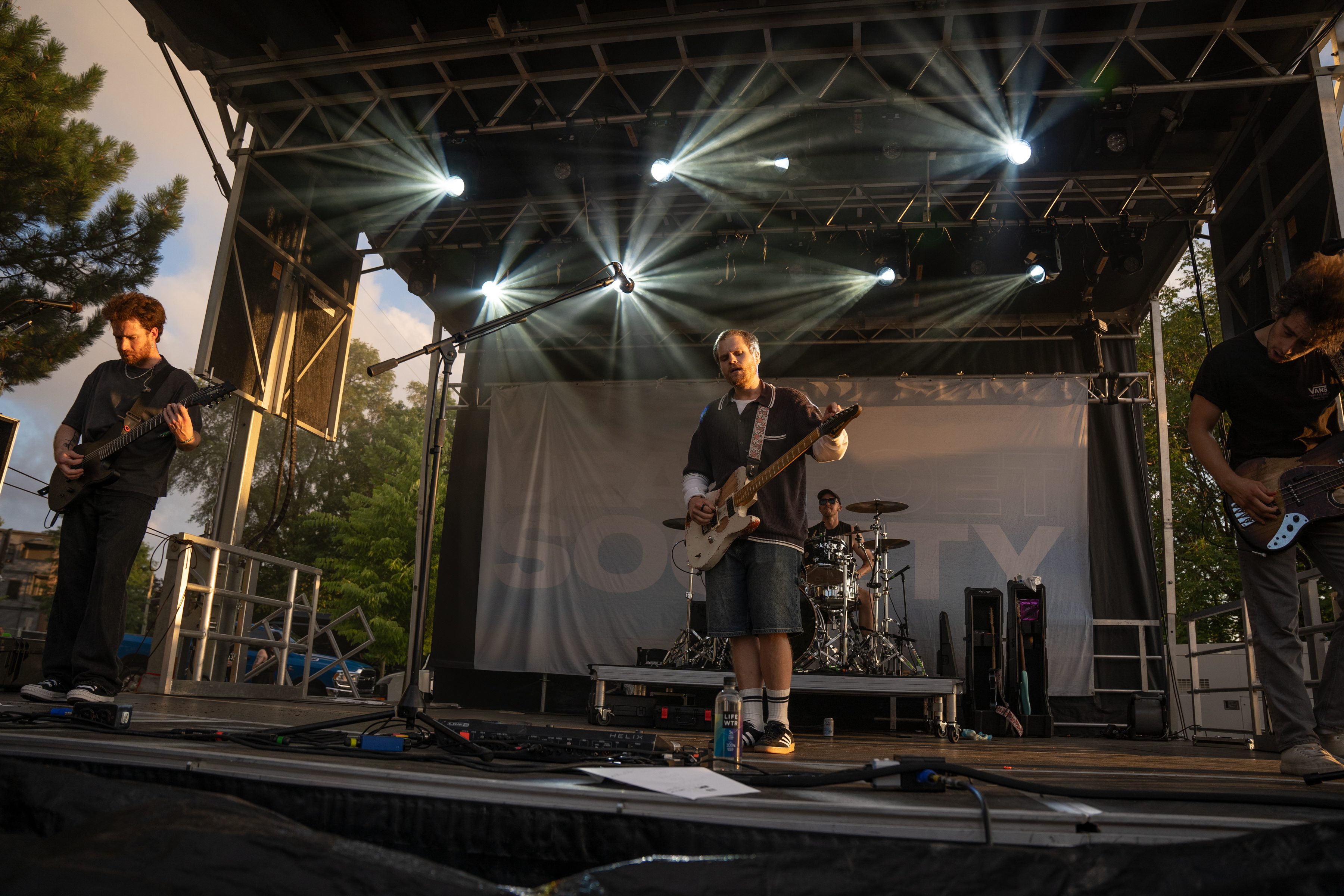 A band performing on stage at the Upheaval Festival, with dynamic lighting and instruments visible.