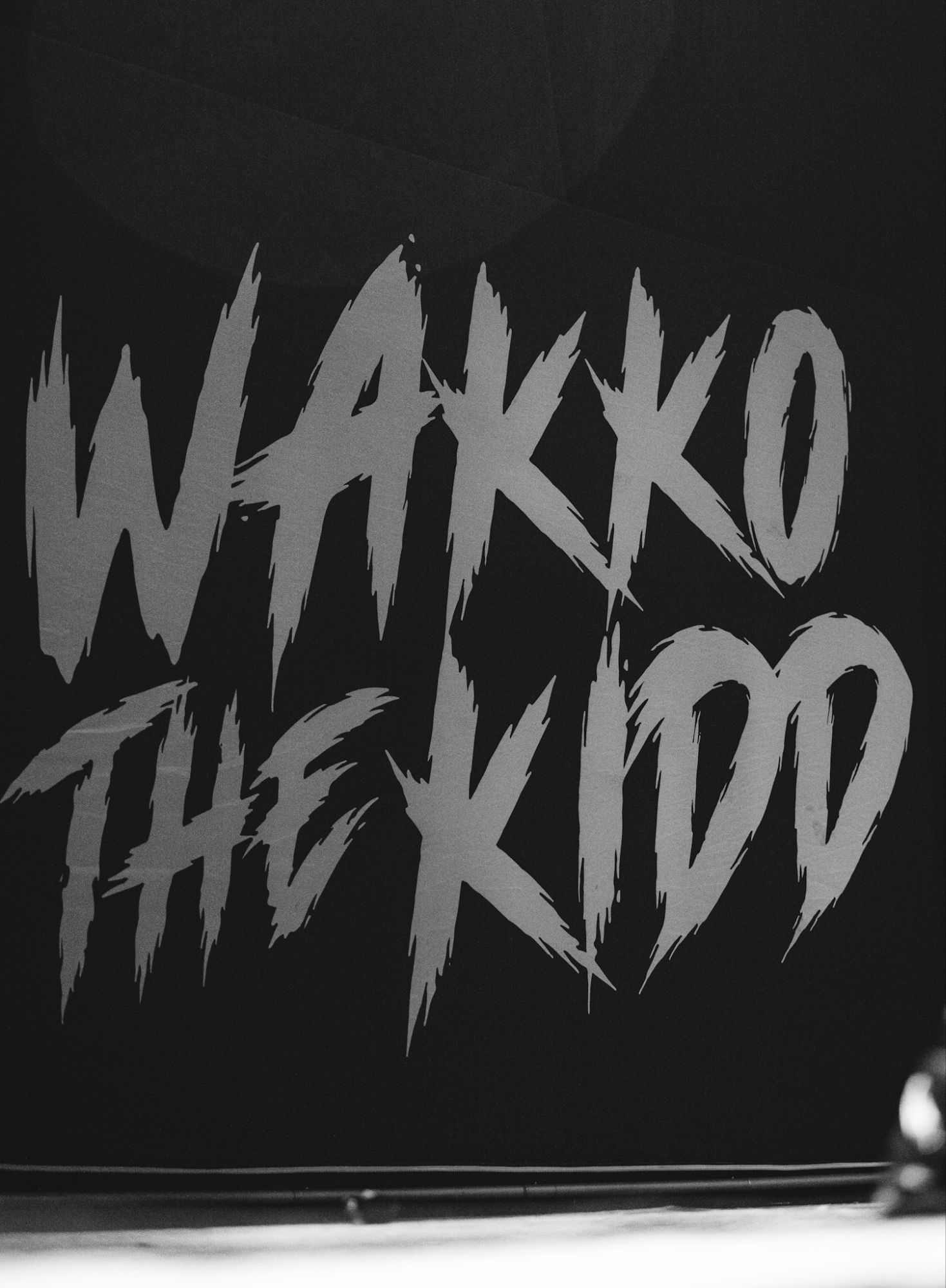 The stage backdrop featuring the bold text 'Wakko The Kidd' in a striking, graffiti-like style.