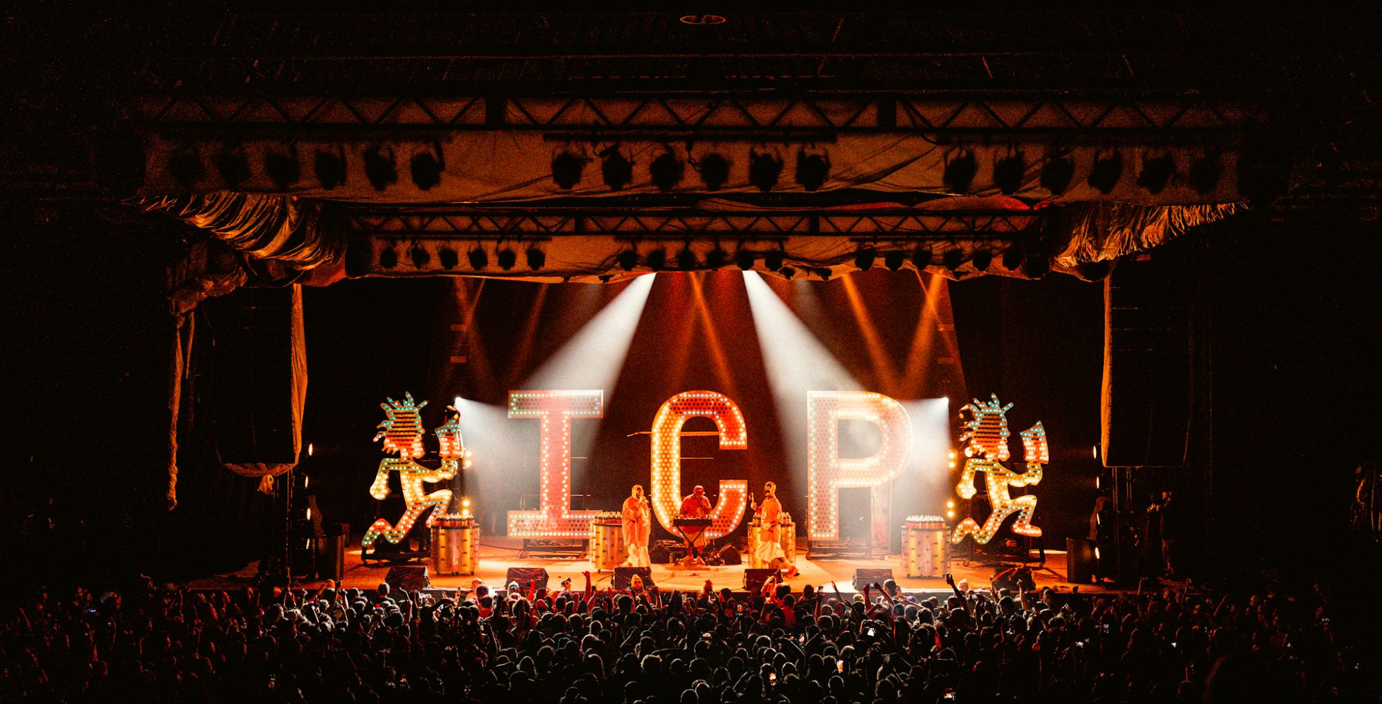 Insane Clown Posse performing on stage at The Bomb Factory in Dallas, Texas, with vibrant I.C.P. marquee lights and a large crowd enjoying the show.