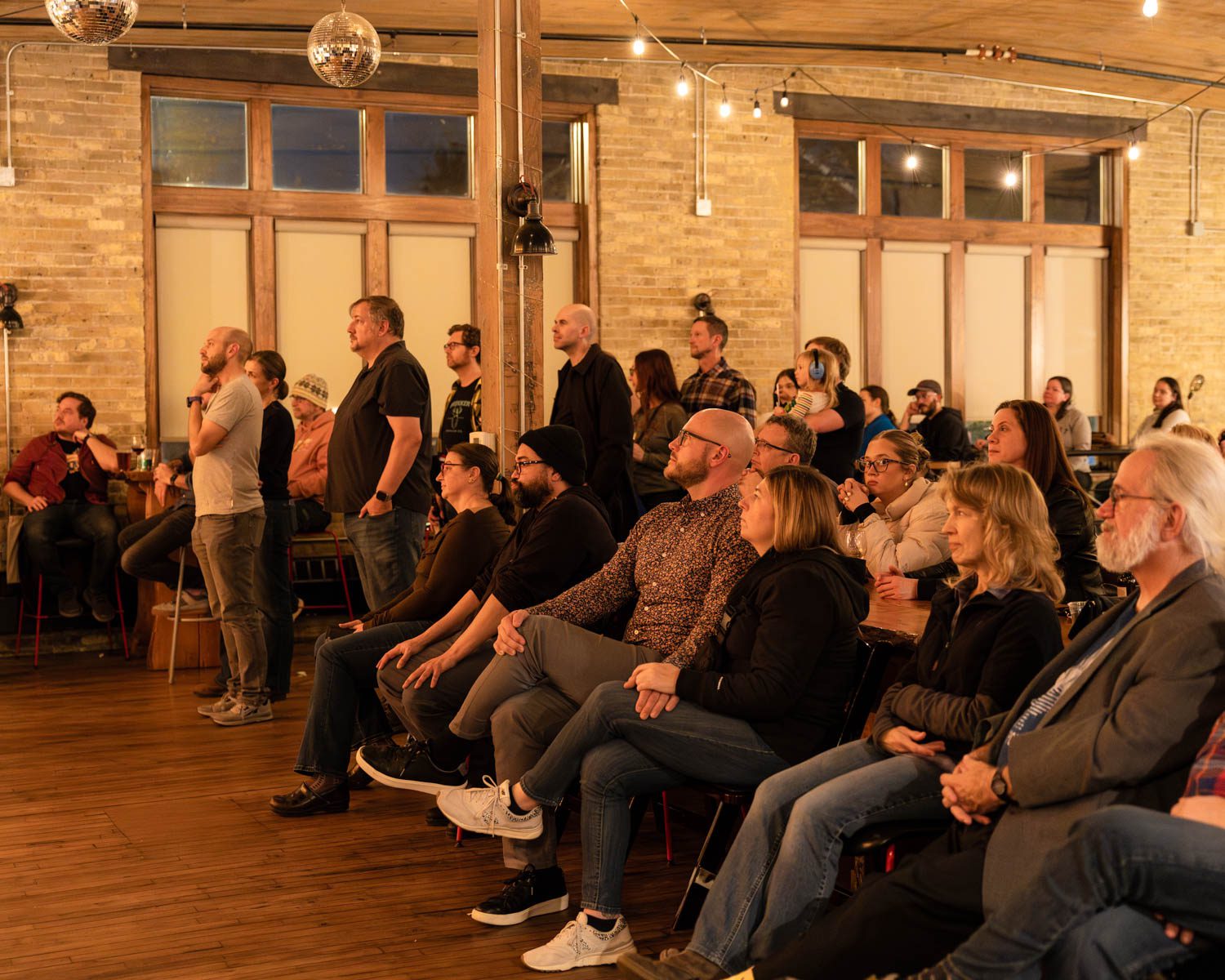 Audience at Anodyne Coffee in Milwaukee, Wisconsin, enjoying a live music performance, with a cozy and intimate atmosphere.