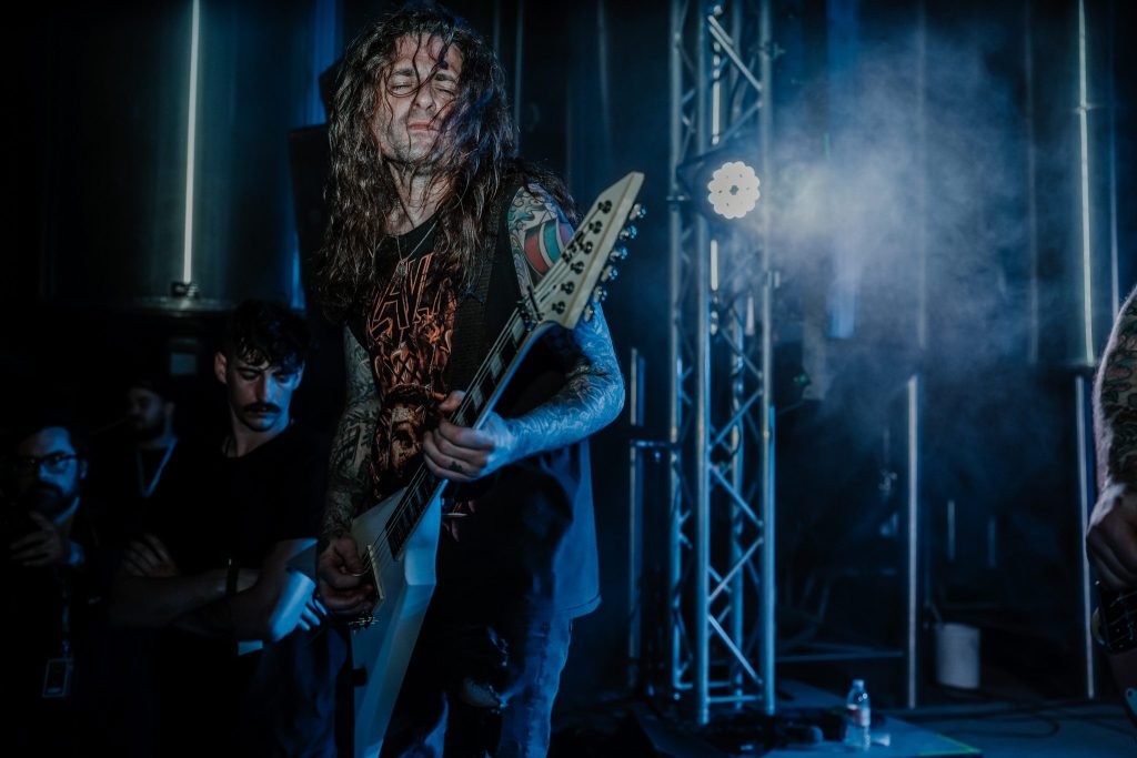 A young woman with long blonde hair holds train tickets in one hand while tears stream down her face, conveying a deep sense of sorrow and longing.