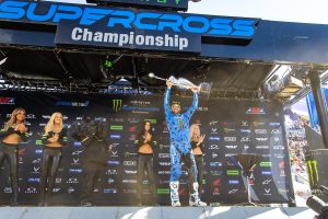 Eli Tomac raising the Monster Energy Supercross Championship trophy at Empower Field at Mile High in Denver after winning the 2022 championship. [SMX League Image]